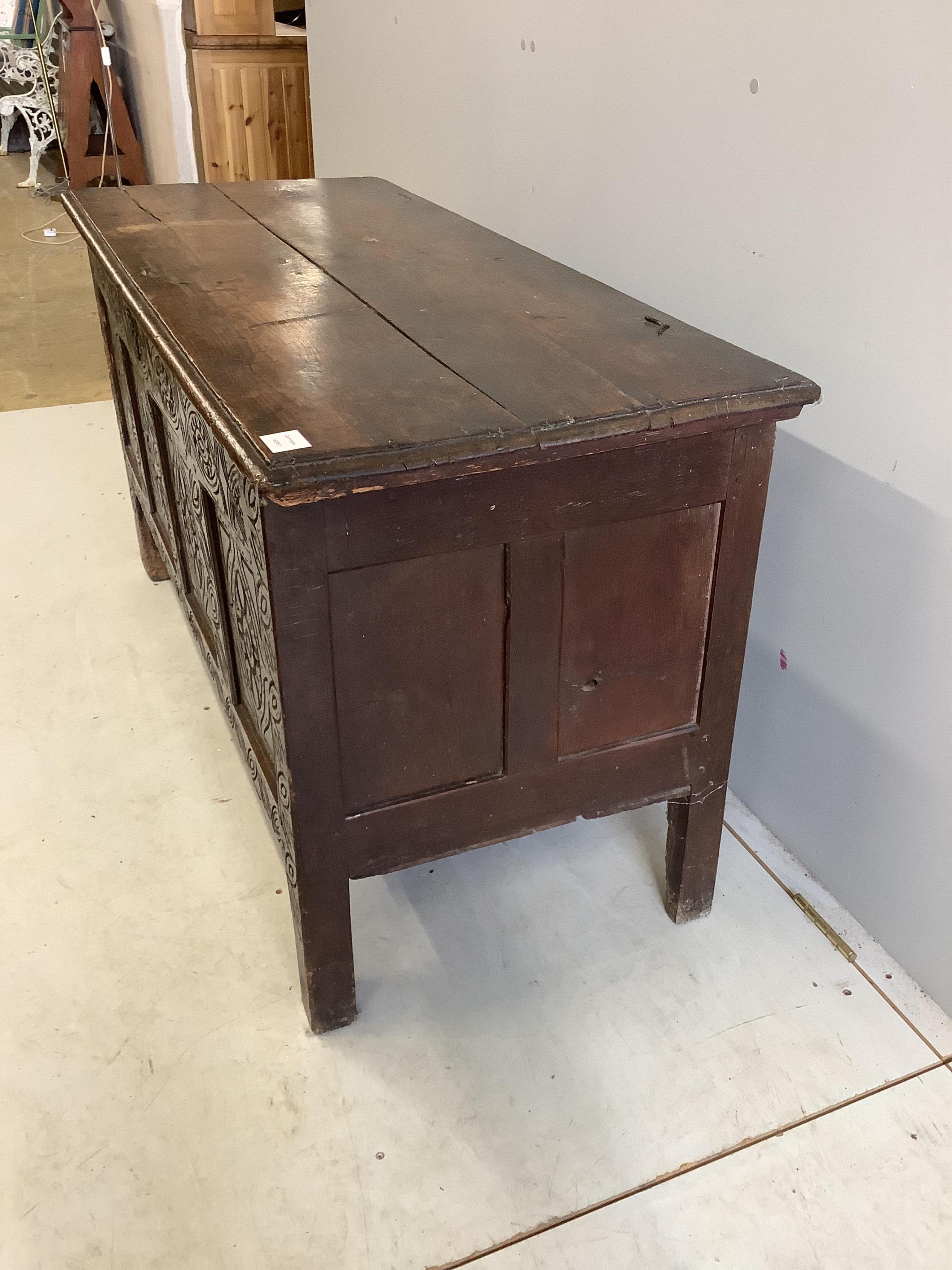 An 18th century carved oak coffer, width 125cm, depth 53cm, height 68cm. Condition - poor